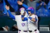 Kansas City Royals' Lane Thomas, right, celebrates after hitting a walkoff home run with third base coach Vance Wilson (17) during a baseball game against the Los Angeles Angels in Kansas City, Mo., Sunday, April 26, 2026. (AP Photo/Colin E. Braley)