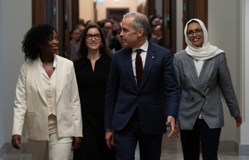 Prime Minister Mark Carney walks to caucus with MP for Terrebonne Tatiana Auguste, MP for University-Rosedale Danielle Martin and MP for Scarborough Southwest Doly Begum on Parliament Hill in Ottawa on Wednesday, April 15, 2026. THE CANADIAN PRESS/Adrian Wyld
