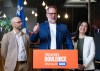 Alexandre Boulerice, centre, federal MP for the riding of Rosemont-La Petite-Patrie flanked by Quebec Solitaire co-spokesperson Ruba Ghazal, right, and Sol Zanetti gives a thumbs up as he announces his intention to leave federal politics and the NDP party to run provincially with Quebec Solidaire, in Montreal on Monday, April 27, 2026. THE CANADIAN PRESS/Christinne Muschi