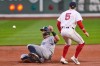 New York Yankees' Aaron Judge, left, beats the throw to Boston Red Sox third baseman Caleb Durbin (5) while advancing on a double by Giancarlo Stanton during the first inning during of a baseball game at Fenway Park, Wednesday, April 22, 2026, in Boston. (AP Photo/Charles Krupa)