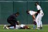 Chicago White Sox left fielder Tanner Murray, second from left, is checked by a team trainer, left, after being injured during the 10th inning of a baseball game against the Washington Nationals in Chicago, Sunday, April 26, 2026. (AP Photo/Nam Y. Huh)