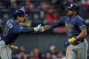 Tampa Bay Rays' Richie Palacios, right, is congratulated by Jonny DeLuca (21) after scoring in the eighth inning of a baseball game against the Cleveland Guardians in Cleveland, Monday, April 27, 2026. (AP Photo/Sue Ogrocki)