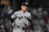 New York Yankees' Aaron Judge rounds the bases after hitting a solo home run in the third inning of a baseball game against the Texas Rangers Monday, April 27, 2026, in Arlington, Texas. (AP Photo/Tony Gutierrez)