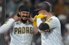 San Diego Padres' Gavin Sheets, right, celebrates his home run with teammate Fernando Tatis Jr. during the eighth inning of a baseball game against the Chicago Cubs Monday, April 27, 2026, in San Diego. (AP Photo/Gregory Bull)