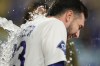 Los Angeles Dodgers' Kyle Tucker is showered with water during an interview after hitting a walk off single during the ninth inning of a baseball game against the Miami Marlins Monday, April 27, 2026, in Los Angeles. (AP Photo/Ryan Sun)