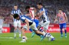 Real Sociedad's Jon Aramburu, left, and Mikel Oyarzabal, centre right, challenge for the ball with Atletico Madrid's Ademola Lookman during the Copa del Rey final soccer match between Atletico Madrid and Real Sociedad in Seville, Spain, Saturday, April. 18, 2026. (AP Photo/Jose Breton)