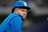FILE - Milwaukee Brewers Jackson Chourio looks on from the dugout railing during the sixth inning of a baseball game against the Washington Nationals, Friday, April 10, 2026, in Milwaukee. (AP Photo/Kayla Wolf, File)
