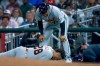 Detroit Tigers' Javier Baez (28) reacts after injuring his right leg running to first base on a ground ball against the Atlanta Braves, as Detroit Tigers first base coach Anthony Sanders (77) looks on during the fifth inning of a baseball game, Tuesday, April 28, 2026, in Atlanta. (AP Photo/Erik S. Lesser)