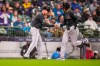 Arizona Diamondbacks' Nolan Arenado rounds the bases on a two-run homer with a shake from third base coach J.R. House during the fourth inning of a baseball game against the Milwaukee Brewers Wednesday, April 29, 2026, in Milwaukee. (AP Photo/Andy Manis)