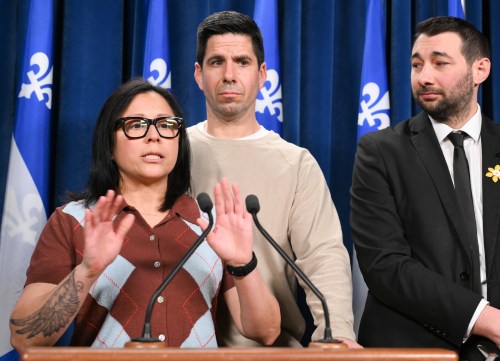 Veronica Martinez, mother of Zachary Miron who died after drinking an energy drink while skiing, speaks at a news conference at the legislature in Quebec City Wednesday, April 1, 2026. Father David Miron and Quebec solidaire MNA Guillaume Cliche-Rivard, look on and react. THE CANADIAN PRESS/Jacques Boissinot