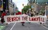 People march towards Parliament Hill on an International Day of Action to Search the Landfills, in Ottawa, on Monday, Sept. 18, 2023. THE CANADIAN PRESS/Justin Tang