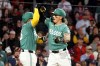Boston Red Sox's Jarren Duran, right, and teammate Carlos Narváez, left, celebrate after Duran's three-run home run during the third inning of a baseball game against the Houston Astros, Friday, May 1, 2026, in Boston. (AP Photo/Mark Stockwell)