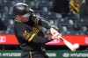 Pittsburgh Pirates catcher Henry Davis connects with a pitch from Cincinnati Reds pitcher Zach Maxwell for a two run home run in the fifth inning of a baseball game in Pittsburgh, Friday, May 1, 2026. (AP Photo/Tom E. Puskar)