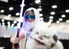 A Star Wars fan with a light sabre and a toy wampa poses for a photo at the Calgary Expo Comics and Entertainment show in Calgary on Friday, April 24, 2026. THE CANADIAN PRESS/Todd Korol
