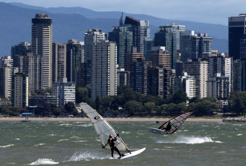 Two men windsurf in the waters off Spanish Banks Beach during a windstorm in Vancouver, B.C., on Monday July 12, 2010. The Vancouver Park Board has reversed a plan to cut back on lifeguards this summer. THE CANADIAN PRESS/Darryl Dyck