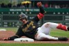 Pittsburgh Pirates' Konnor Griffin slides into third base on his triple off Cincinnati Reds pitcher Brock Burke in the fourth inning of a baseball game in Pittsburgh, Saturday, May 2, 2026. (AP Photo/Tom E. Puskar)