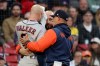 Houston Astros' Christian Walker, left, is assisted by coaches after getting hit in the head by a pitch during the ninth inning of a baseball game against the Boston Red Sox, Saturday, May 2, 2026, in Boston. (AP Photo/Mark Stockwell)