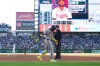 Atlanta Braves' Ronald Acuña Jr., center left, walks gingerly after being injured while running out a groundout as first base umpire Bill Miller, center right, looks on in the second inning of a baseball game against the Colorado Rockies, Saturday, May 2, 2026, in Denver. (AP Photo/David Zalubowski)