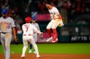 Los Angeles Angels' Oswald Peraza, right, celebrates his walk off single with Jo Adell, center, as New York Mets second baseman Marcus Semien walks off the field in the 10th inning of a baseball game Saturday, May 2, 2026, in Anaheim, Calif. (AP Photo/Mark J. Terrill)