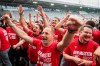Thun head coach Mauro Lustrinelli, centre, assistant coach Nelson Ferreira, left, and sporting director Dominik Albrecht, right, celebrate the championship title in Thun, Switzerland, Sunday, May 3, 2026. (Alessandro della Valle/Keystone via AP)