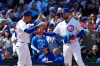 Chicago Cubs' Michael Busch, right, celebrates with third base coach Quintin Berry, left, after hitting a three-run triple during the fifth inning of a baseball game against the Arizona Diamondbacks in Chicago, Sunday, May 3, 2026. (AP Photo/Nam Y. Huh)