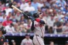 Atlanta Braves' Jonah Heim follows the flight of his sacrifice fly to drive in a run off Colorado Rockies relief pitcher Antonio Senzatela in the fifth inning of a baseball game, Sunday, May 3, 2026, in Denver. (AP Photo/David Zalubowski)