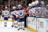 Edmonton Oilers center Connor McDavid, center, is congratulated by teammates after scoring during the third period of Game 3 in the first round of the NHL hockey Stanley Cup playoffs series against the Anaheim Ducks, Friday, April 24, 2026, in Anaheim, Calif. (AP Photo/Mark J. Terrill)