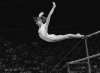 Nadia Comaneci, of Romania, dismounts from the uneven parallel bars during a perfect 