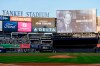 A scoreboard displays late former New York Yankees broadcaster John Sterling during a tribute to Sterling ahead of a baseball game between the New York Yankees and the Baltimore Orioles, Monday, May 4, 2026, in New York. (AP Photo/Yuki Iwamura)