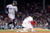 New York Yankees' Randal Grichuk, left, is safe at first base before the tag of Boston Red Sox first baseman Willson Contreras, right, during the sixth inning of a baseball game, on Tuesday, April 21, 2026, in Boston. (AP Photo/CJ Gunther)