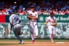 St. Louis Cardinals' JJ Wetherholt, center, turns a double play past Los Angeles Dodgers' Dalton Rushing, left, during the fourth inning of a baseball game Sunday, May 3, 2026, in St. Louis. (AP Photo/Scott Kane)