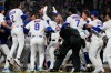 Chicago Cubs' Michael Conforto, center, celebrates with teammates after hitting the winning solo home run during the ninth inning of a baseball game against the Cincinnati Reds in Chicago, Monday, May 4, 2026. (AP Photo/Nam Y. Huh)