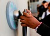 FILE - A middle school student unlocks a Yondr pouch on an unlocking base at Bayside Academy while others wait in line for their turn to unlock their pouch at the end of the school day Aug. 16, 2024, in San Mateo, Calif. (Lea Suzuki/San Francisco Chronicle via AP, File)