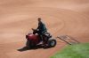 Mark Razum, head groundskeeper for Coors Field, drags the diamond before the Colorado Rockies host the Los Angeles Dodgers in a baseball game Sunday, April 19, 2026, in Denver. (AP Photo/David Zalubowski)