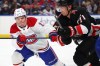 Canadiens right wing Cole Caufield (13) and Sabres centre Ryan McLeod (71) battle for position during the second period of an NHL game. (AP Photo/Jeffrey T. Barnes)