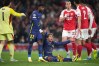 Atletico Madrid's Giuliano Simeone, on the ground, gestures after falling down in a clash in the box during a Champions League semifinal, second leg, soccer match between Arsenal FC and Atletico Madrid in London, Tuesday, May 5, 2026. (AP Photo/Alastair Grant)