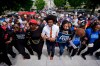 Rep. Justin J. Pearson, D-Memphis, center, marches with protesters before a special session of the state legislature to redraw U.S. Congressional voting maps, in Nashville, Tenn., Tuesday, May 5, 2026. (AP Photo/George Walker IV)