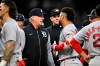 Detroit Tigers manager A.J. Hinch, left, talks with Boston Red Sox's Willson Contreras after Trevor Story was hit by a pitch during the fourth inning of a baseball game, Tuesday, May 5, 2026, in Detroit. (AP Photo/Jose Juarez)
