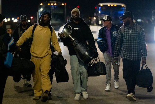 Toronto Argonauts wide receiver DaVaris Daniels carries the Grey Cup while walking alongside his teammates as they arrive at Toronto Pearson International Airport in Mississauga, Ont., Monday, Nov. 18, 2024. The Argonauts defeated the Winnipeg Blue Bombers on Sunday to win the cup. THE CANADIAN PRESS/Arlyn McAdorey
