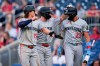 Minnesota Twins' Luke Keaschall (15) and Kody Clemens, center, celebrate with Royce Lewis (23) after scoring against the Washington Nationals on a double hit by Brooks Lee during the second inning of a baseball game, Tuesday, May 5, 2026, in Washington. (AP Photo/Jess Rapfogel)