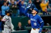 Kansas City Royals' Michael Massey, reacts as he celebrates his two-run home run as he crosses home plate near Cleveland Guardians catcher Bo Naylor, left, during the fourth inning of a baseball game against the Cleveland Guardians in Kansas City, Mo., Tuesday, May 5, 2026. (AP Photo/Colin E. Braley)
