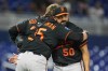 Baltimore Orioles closing pitcher Rico Garcia (50) gets a hug from catcher Adley Rutschman (35) after defeating the Miami Marlins during in a baseball game, Tuesday, May 5, 2026, in Miami. (AP Photo/Rebecca Blackwell)