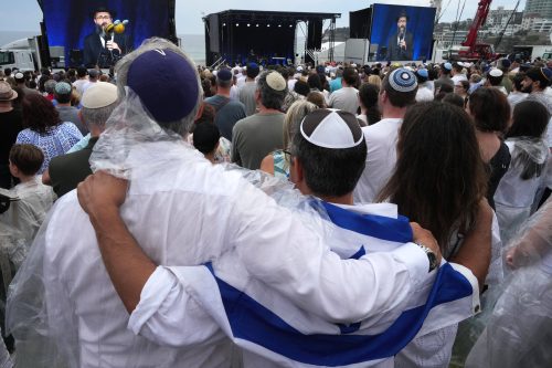 FILE - People attend a ceremony to mark the National Day of Reflection for victims and survivors, at Bondi Beach in Sydney, Sunday, Dec. 21, 2025, following the Bondi shooting on Dec. 14. (AP Photo/Mark Baker,File)
