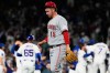Cincinnati Reds relief pitcher Emilio Pagán (15) walks off the field after Chicago Cubs' Michael Conforto hit the winning solo home run during the ninth inning of a baseball game in Chicago, Monday, May 4, 2026. (AP Photo/Nam Y. Huh)