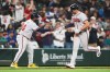 Atlanta Braves' Matt Olson greets third base coach Tommy Watkins while jogging home after hitting a solo home run against the Seattle Mariners during the ninth inning of a baseball game, Tuesday, May 5, 2026, in Seattle. (AP Photo/Lindsey Wasson)