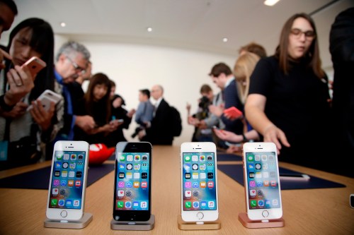 FILE- In this March 21, 2016, file photo members of the media and invited guests take a look at the new iPhone SE during an event at Apple headquarters in Cupertino, Calif. (AP Photo/Marcio Jose Sanchez, file)