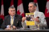 Conservative MP for Selkirk-Interlake-Eastman James Bezan looks on as Ardeshir Zarezadeh, president of the International Centre for Human Rights, holds up a paper during a news conference in Ottawa, Wednesday, May 6, 2026. THE CANADIAN PRESS/Adrian Wyld