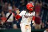 Washington Nationals' CJ Abrams tosses his bat as he watches his grand slam during the eighth inning of a baseball game against the Minnesota Twins, Wednesday, May 6, 2026, in Washington. (AP Photo/Nick Wass)