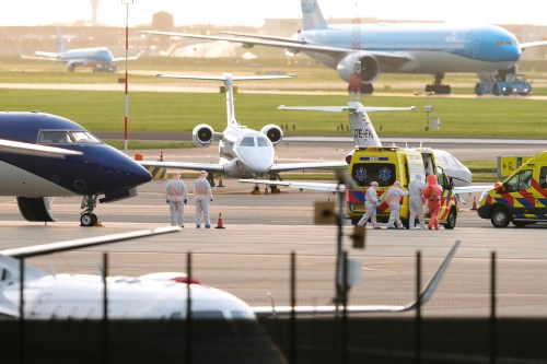 Medics escort patients, evacuated from the MV Hondius cruise ship with suspected hantavirus infection, to an ambulance after being flown to Schiphol airport, Amsterdam, Netherlands, Wednesday, May 6, 2026. (AP Photo/Peter Dejong)