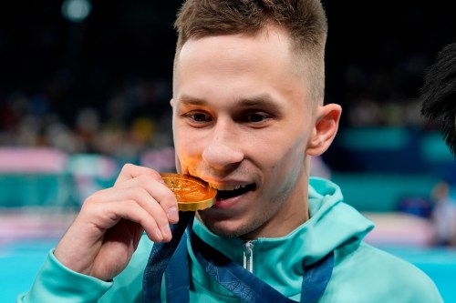 FILE - Ivan Litvinovich of the Individual Neutral Athletes celebrates after winning the gold medal during the men's trampoline finals in Bercy Arena at the 2024 Summer Olympics, Friday, Aug. 2, 2024, in Paris, France. (AP Photo/Charlie Riedel, File)